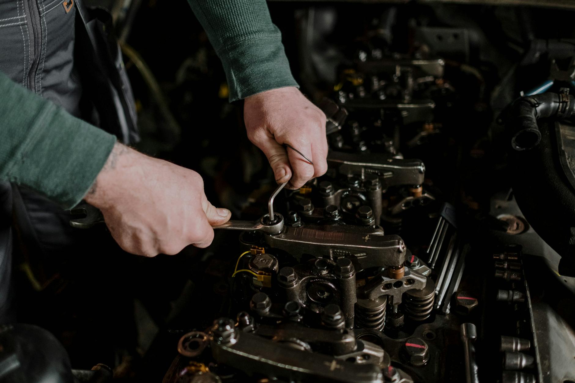 Appliance repair technician diagnosing a unit with tools